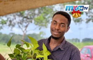 Flower Community Fair 2025 Concludes With Strong Call for Practical Green Living Man holding a flower pot. Creeping plant overflows from the pot